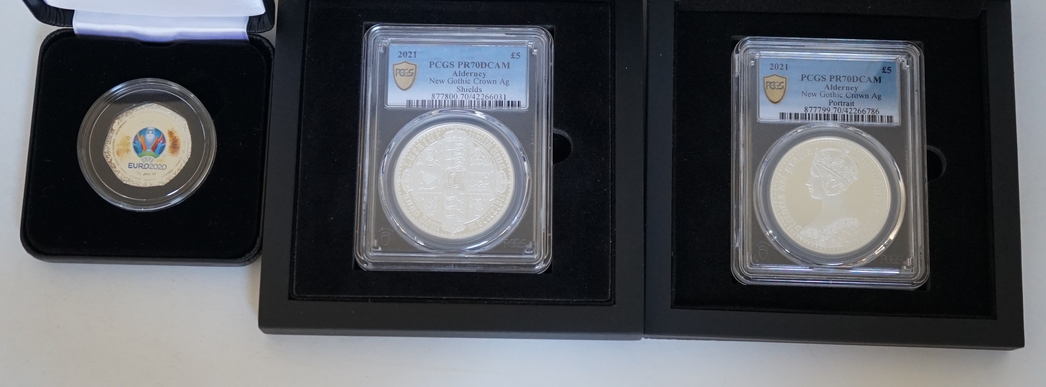 Elizabeth II proof silver coins, two 2021 Alderney QEII New Gothic crown proof silver £5 coins, Queen Victoria portrait and Gothic cruciform Shields reverse, both PCGS slabbed and graded PR70DCAM and a UEFA Euro 2020 Sol